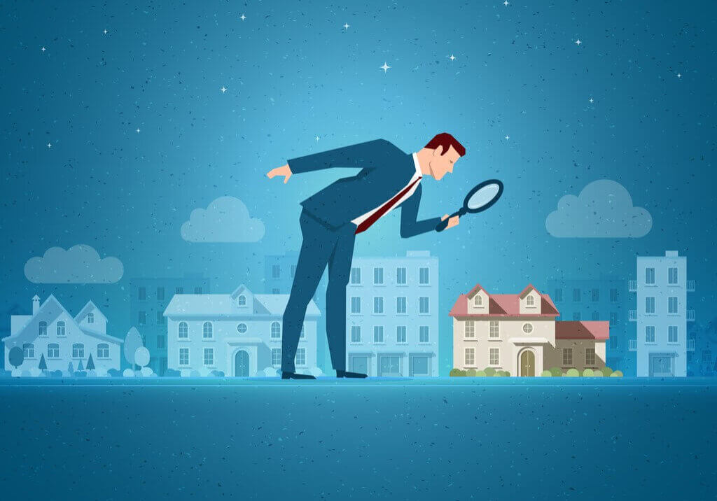 Magnifying glass over real estate assets- smaller